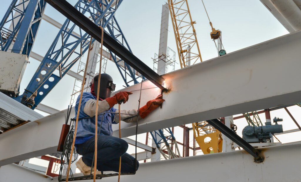 welder with protective mask welding metal and sparks